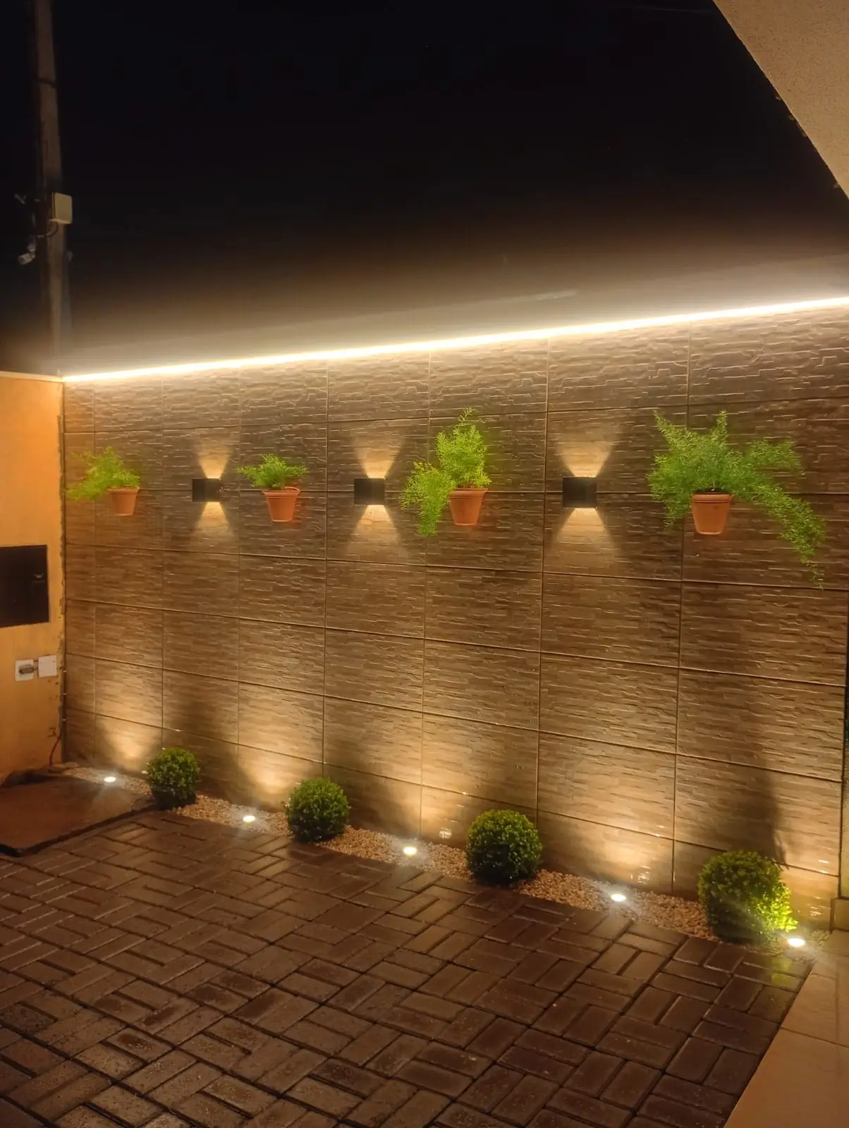 Área externa com iluminação de muro instalada.